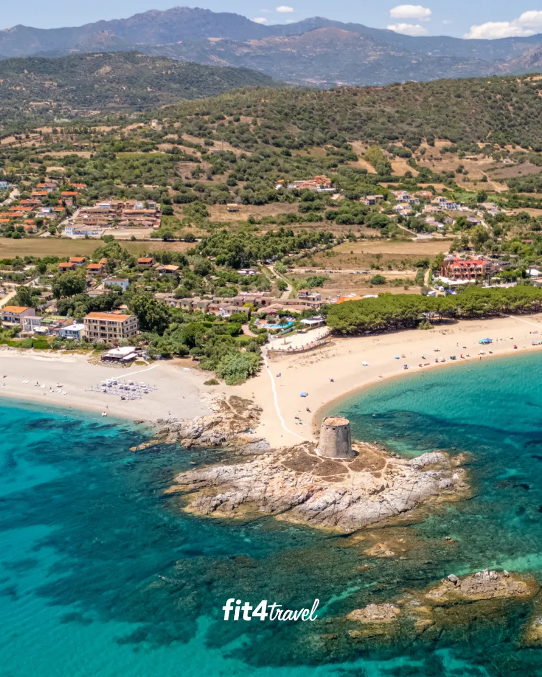 The beaches and green hills of Bari Sardo, home of Hotel Galanias, with the old watchtower on the rocks