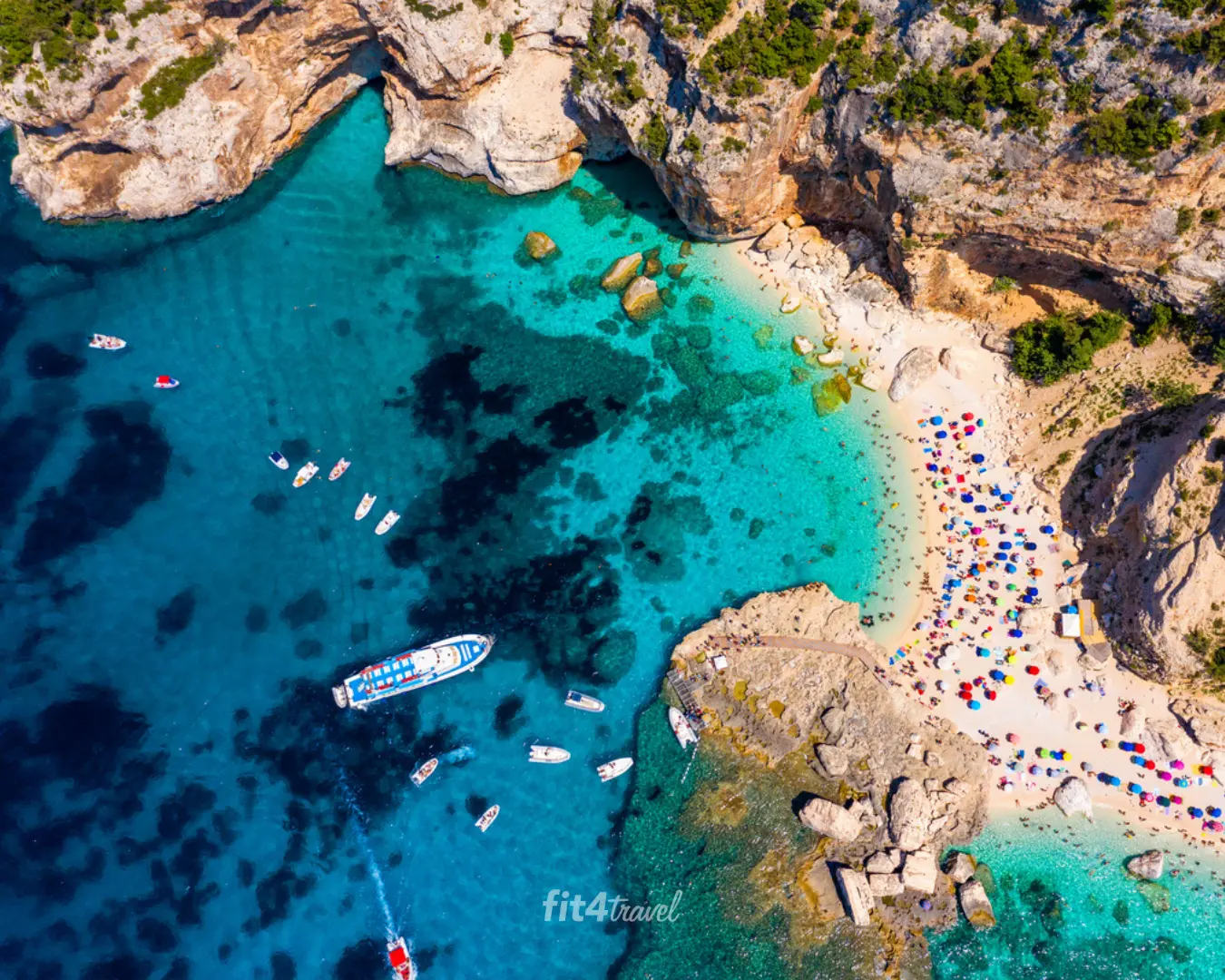 Aerial view of boats anchored in the clear blue water off Cala Goloritzè beach
