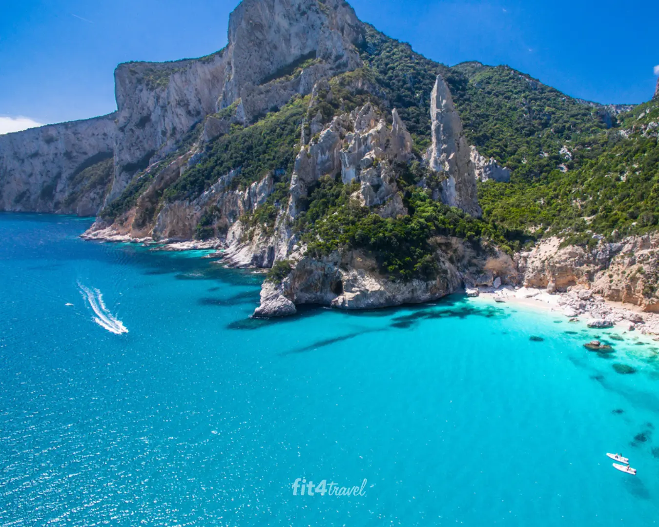 Turquoise water below the limestone cliffs and rock spire at Cala Goloritzè on Sardinia's Baunei coast